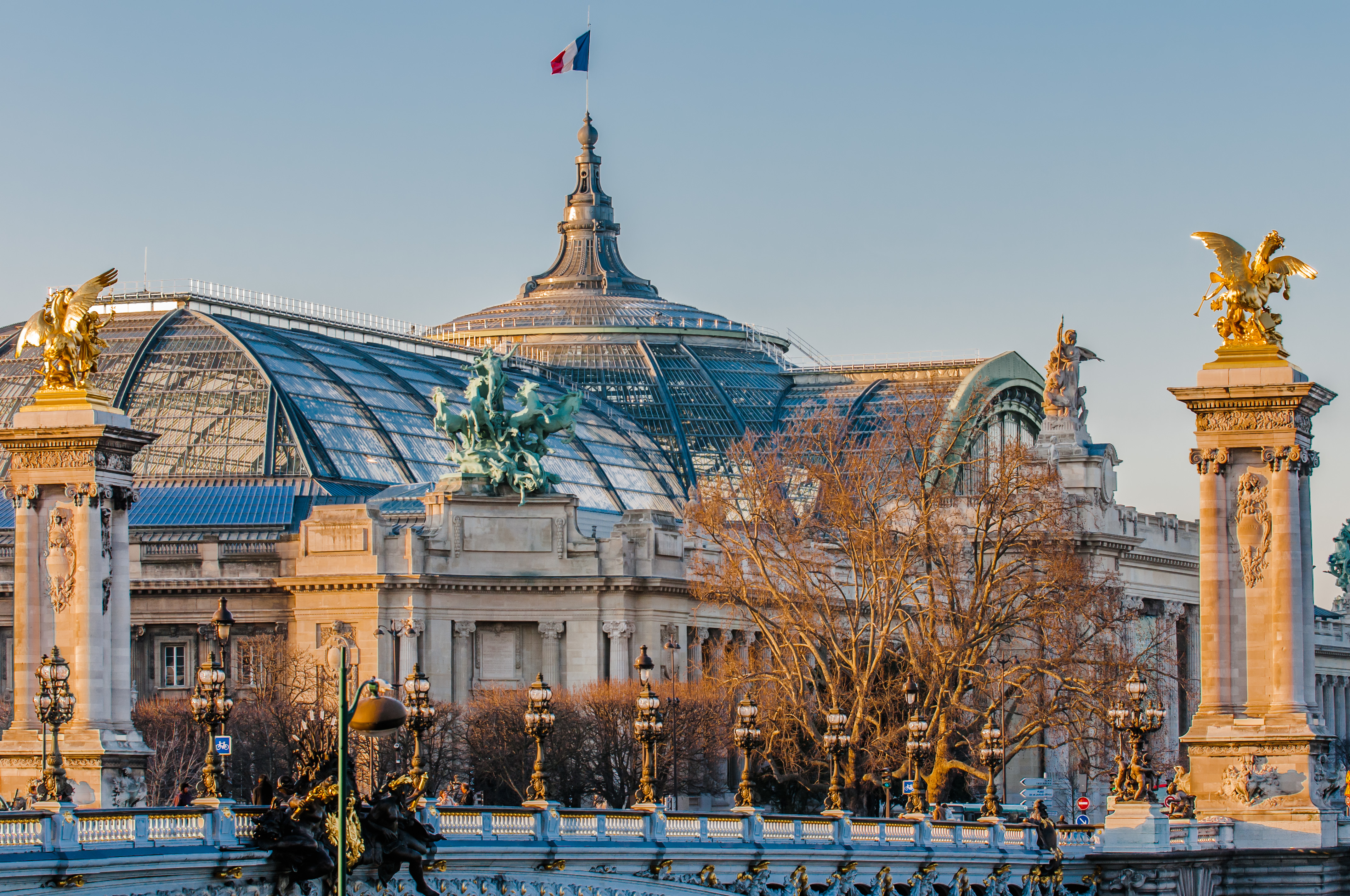 Grand palais Paris with flag on roof and bridge with columns Paris