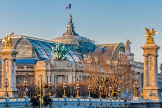 Grand palais Paris with flag on roof and bridge with columns Paris