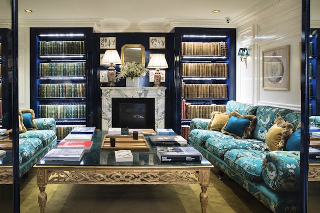 Lobby area with turqouise sofas, book cases and coffee tables