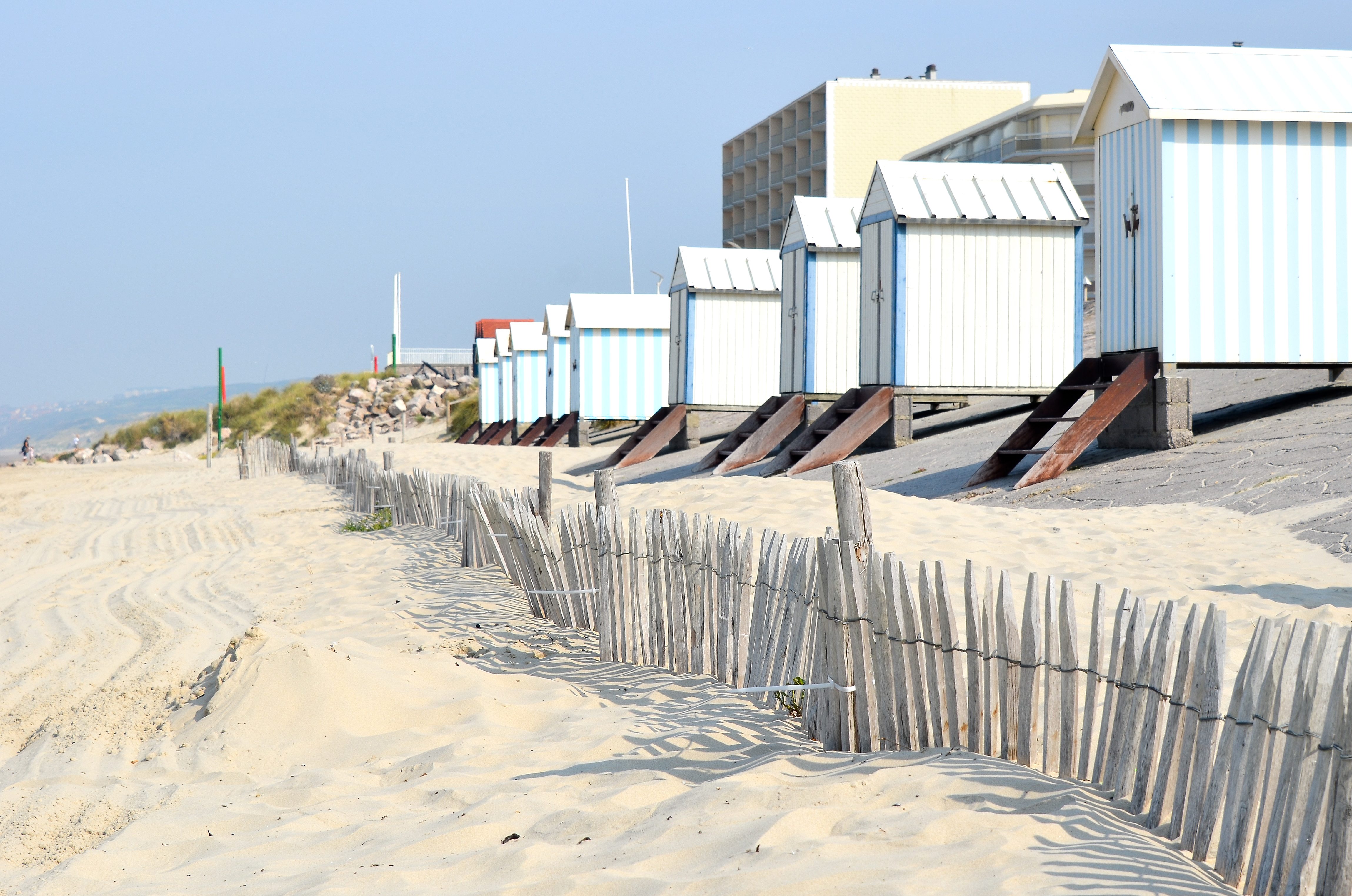 Pastel coloured wooden beach huts on the sandy beach at Hardelot in Pas de Calais
