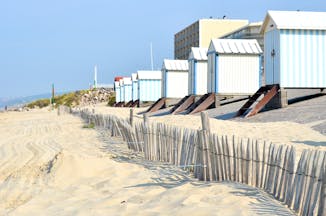 Pastel coloured wooden beach huts on the sandy beach at Hardelot in Pas de Calais