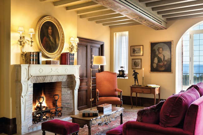 La Bastide de Gordes Provence lounge with sofa with two large paintings and a large fireplace