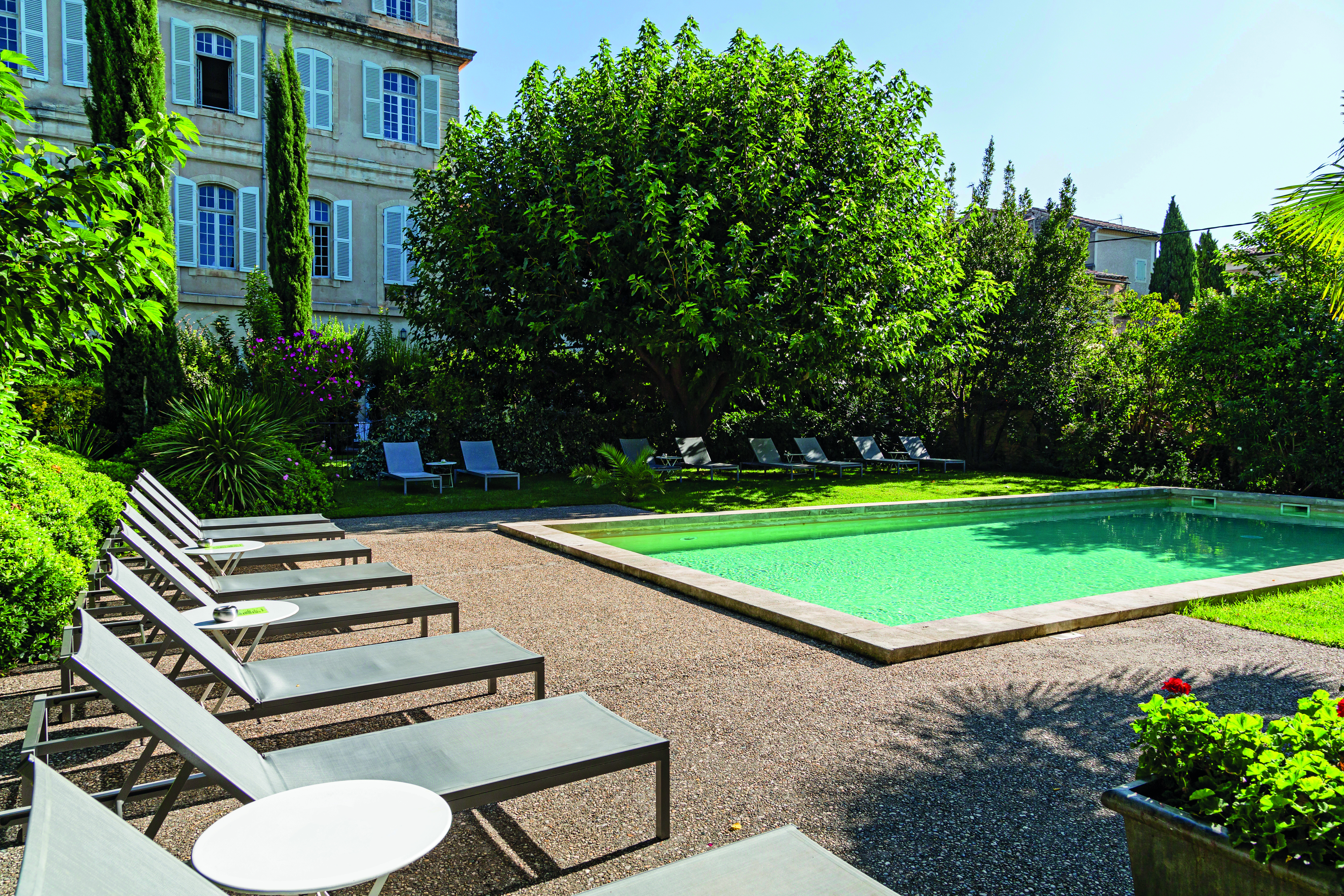 Chateau de Mazan Provence outdoor swimming pool surrounded by trees and sun loungers