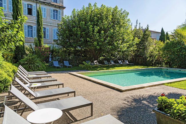 Chateau de Mazan Provence outdoor swimming pool surrounded by trees and sun loungers