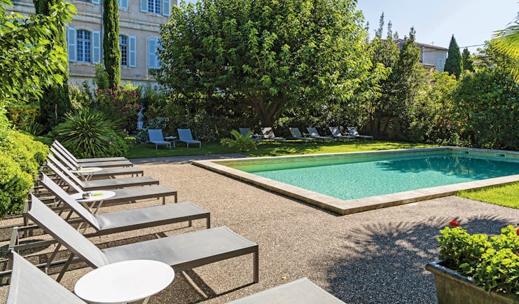 Chateau de Mazan Provence outdoor swimming pool surrounded by trees and sun loungers