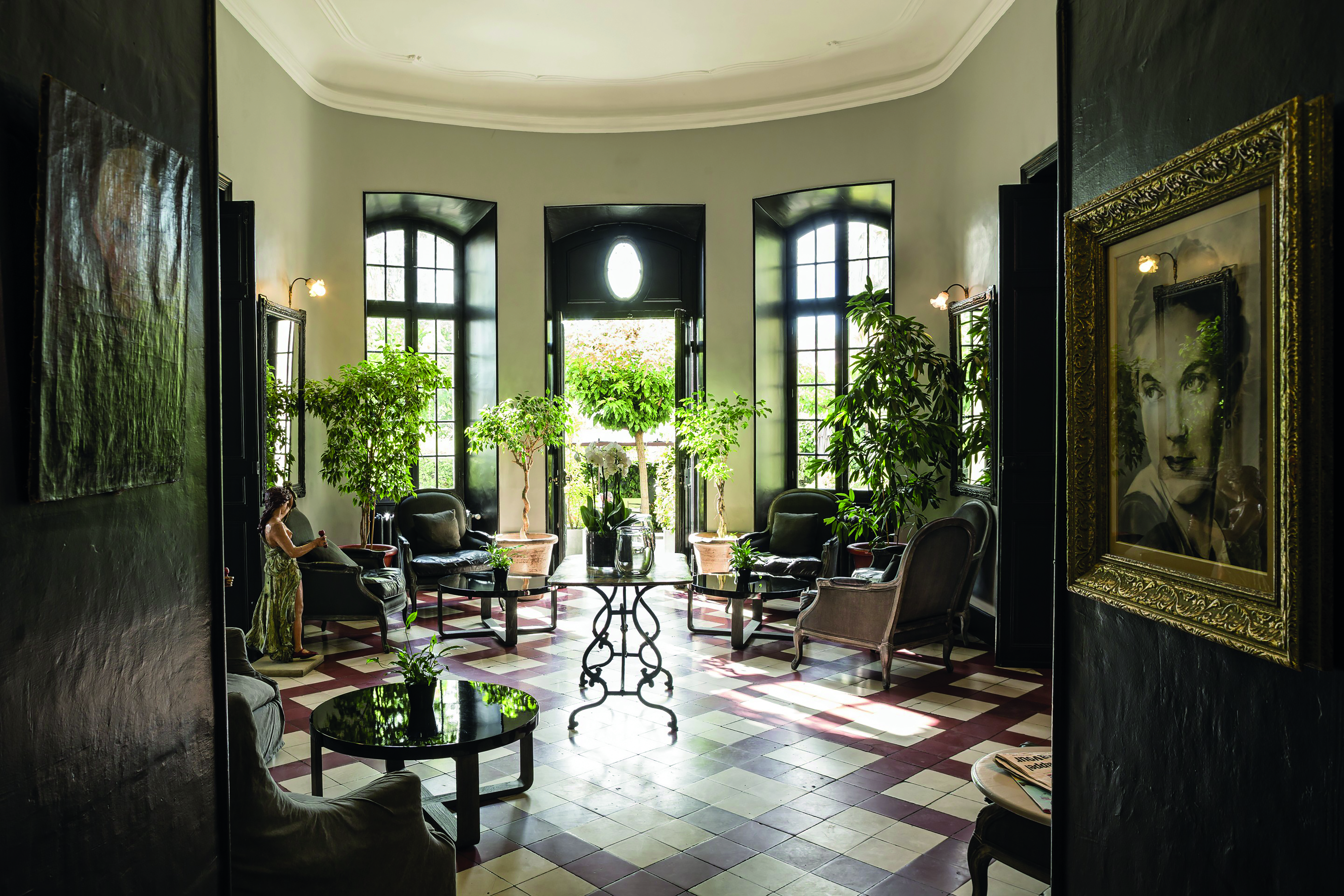 Chateau de Mazan Provence winter garden lounge painting of a woman several chairs and plants