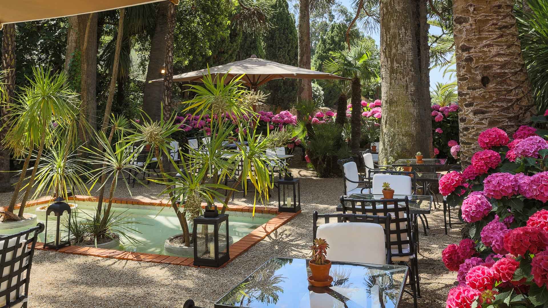 Chateau de Valmer iron backed chairs and umbrellas