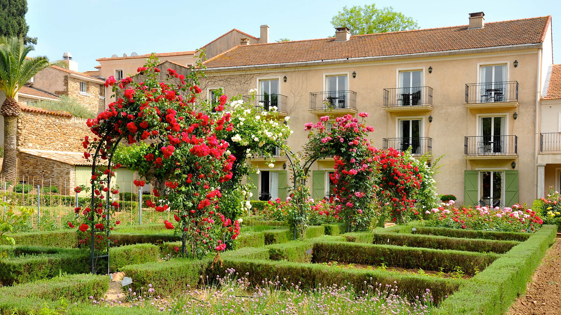 Chateau de Valmer exterior of house with roses and flower beds
