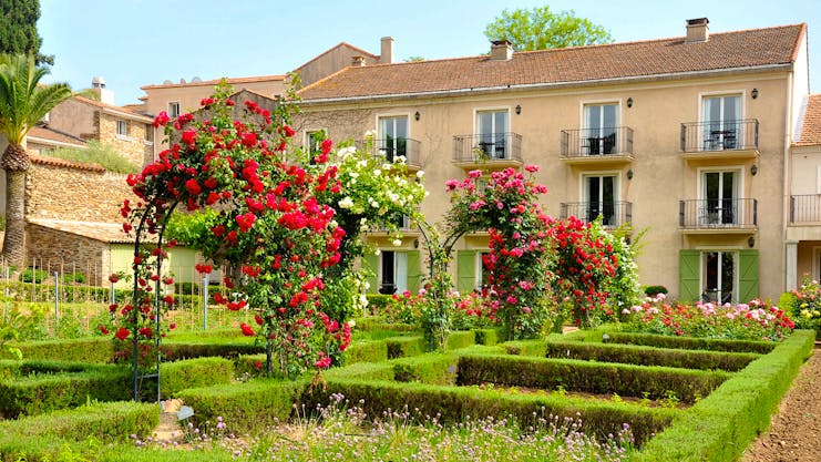 Chateau de Valmer exterior of house with roses and flower beds