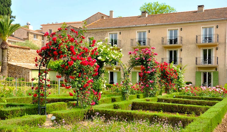 Chateau de Valmer exterior of house with roses and flower beds