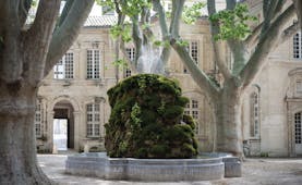 Le Cloitre Saint Louis Avignon exterior fountain large stone building and trees