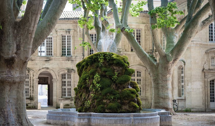 Le Cloitre Saint Louis Avignon exterior fountain large stone building and trees