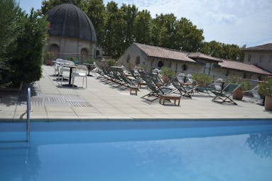Le Cloitre Saint Louis Avignon rooftop pool with wooden and green sun loungers