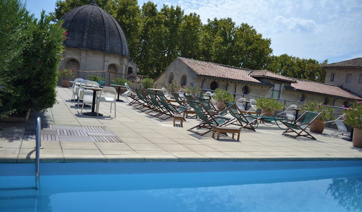 Le Cloitre Saint Louis Avignon rooftop pool with several wooden sun loungers