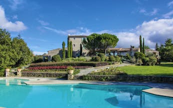 Domaine de Capelongue Provence exterior swimming pool stone building and trees 