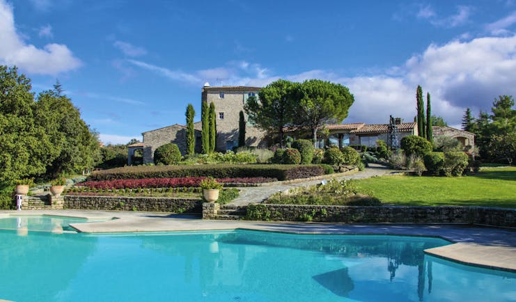 Domaine de Capelongue Provence exterior swimming pool stone building and trees 