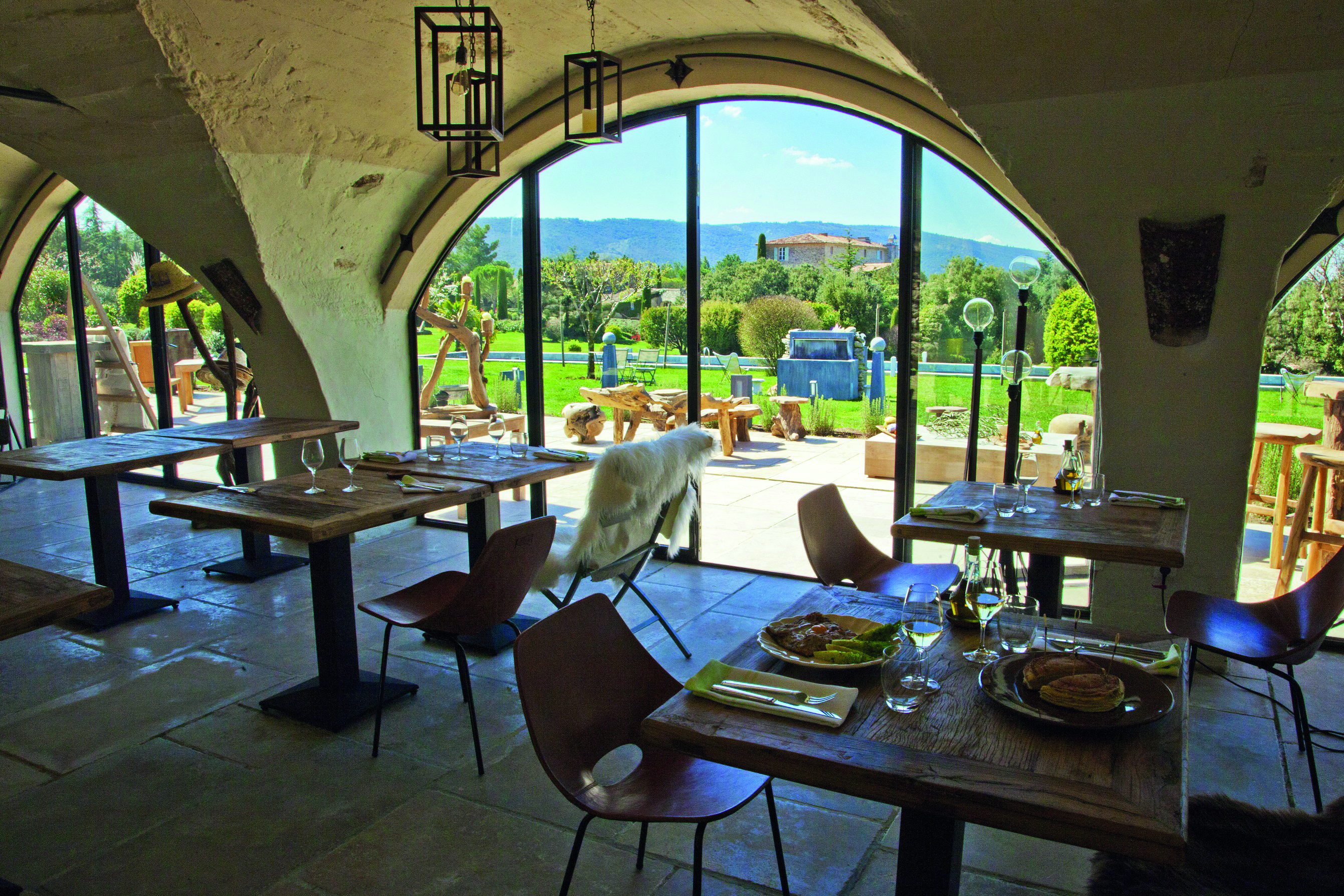 Domaine de Capelongue Provence restaurant dining area with large windows overlooking the countryside