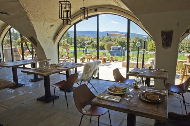 Domaine de Capelongue Provence restaurant dining area with large windows overlooking the countryside