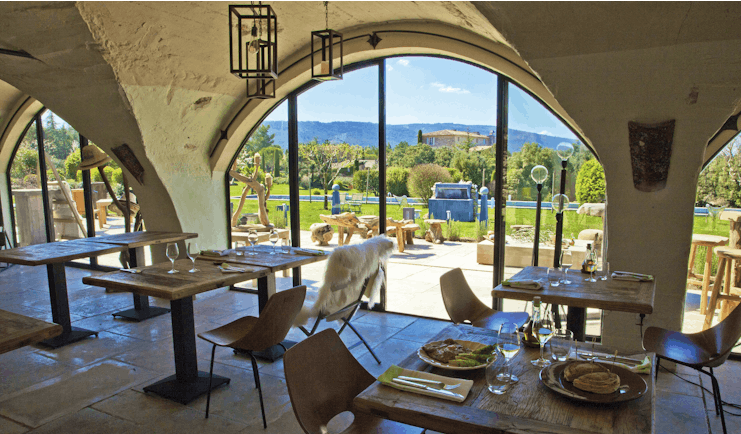 Domaine de Capelongue Provence restaurant dining area with large windows overlooking the countryside