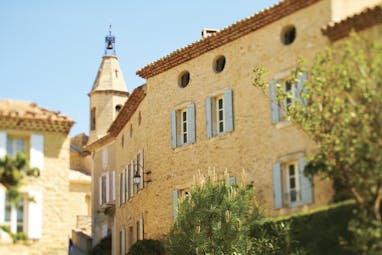 Hotel Crillon le Brave Provence exterior building yellow stone building round windows and shutters