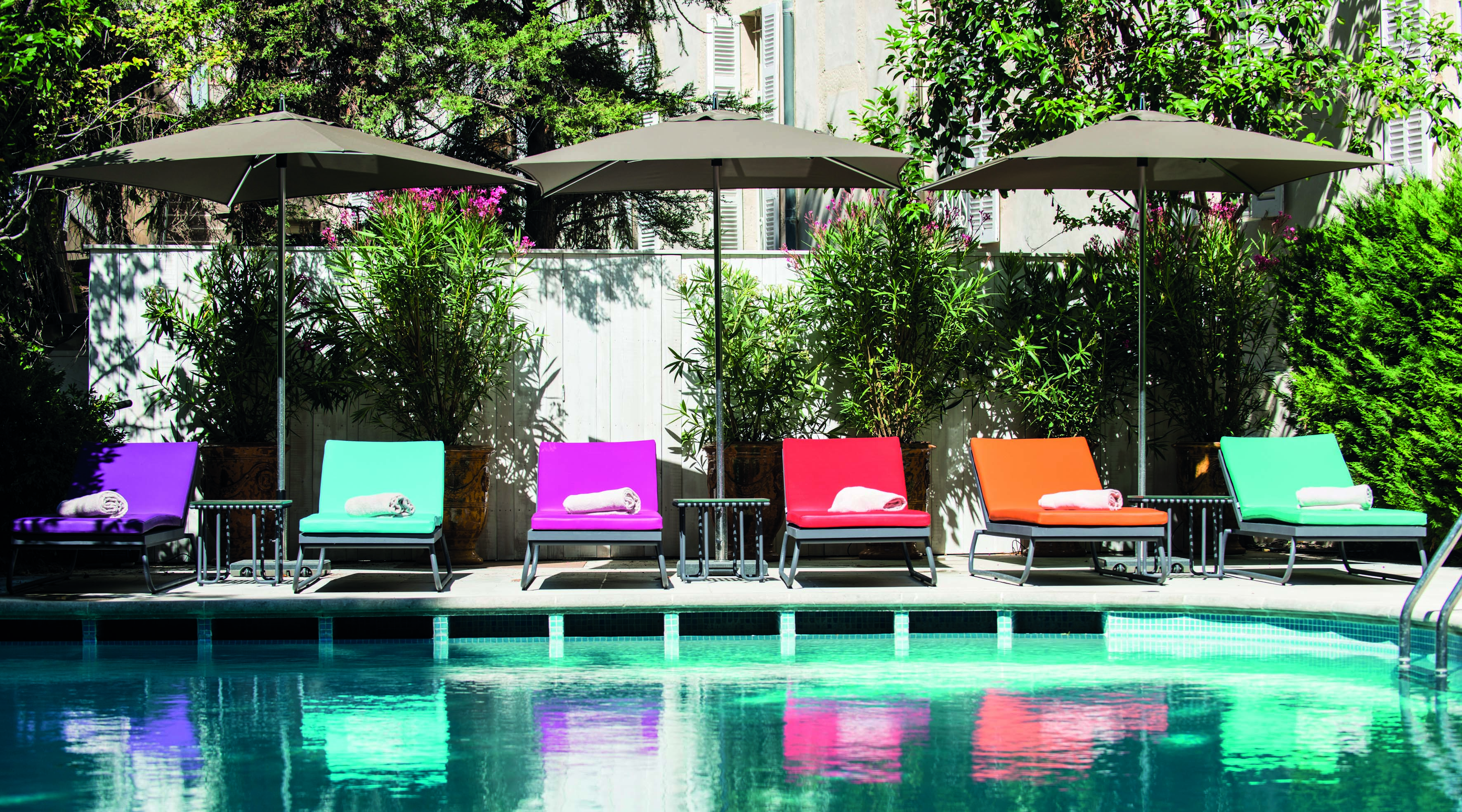 Hotel Jules Cesar Provence outdoor pool loungers and umbrellas