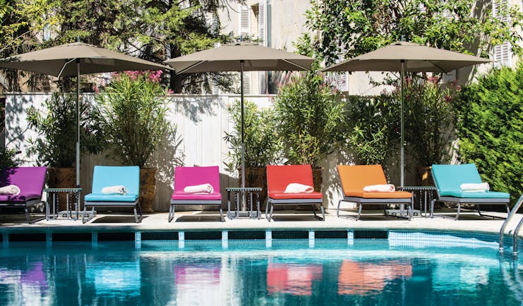 Hotel Jules Cesar Provence outdoor pool loungers and umbrellas