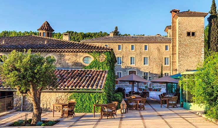 Chateau de Berne Provence outdoor patio stone building with foliage on the walls