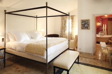 La Bastide de Moustiers Provence aviary bedroom with four poster bed view into a red bathroom