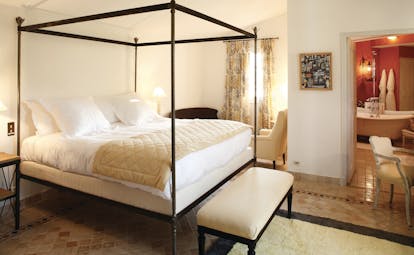 La Bastide de Moustiers Provence aviary bedroom with four poster bed view into a red bathroom