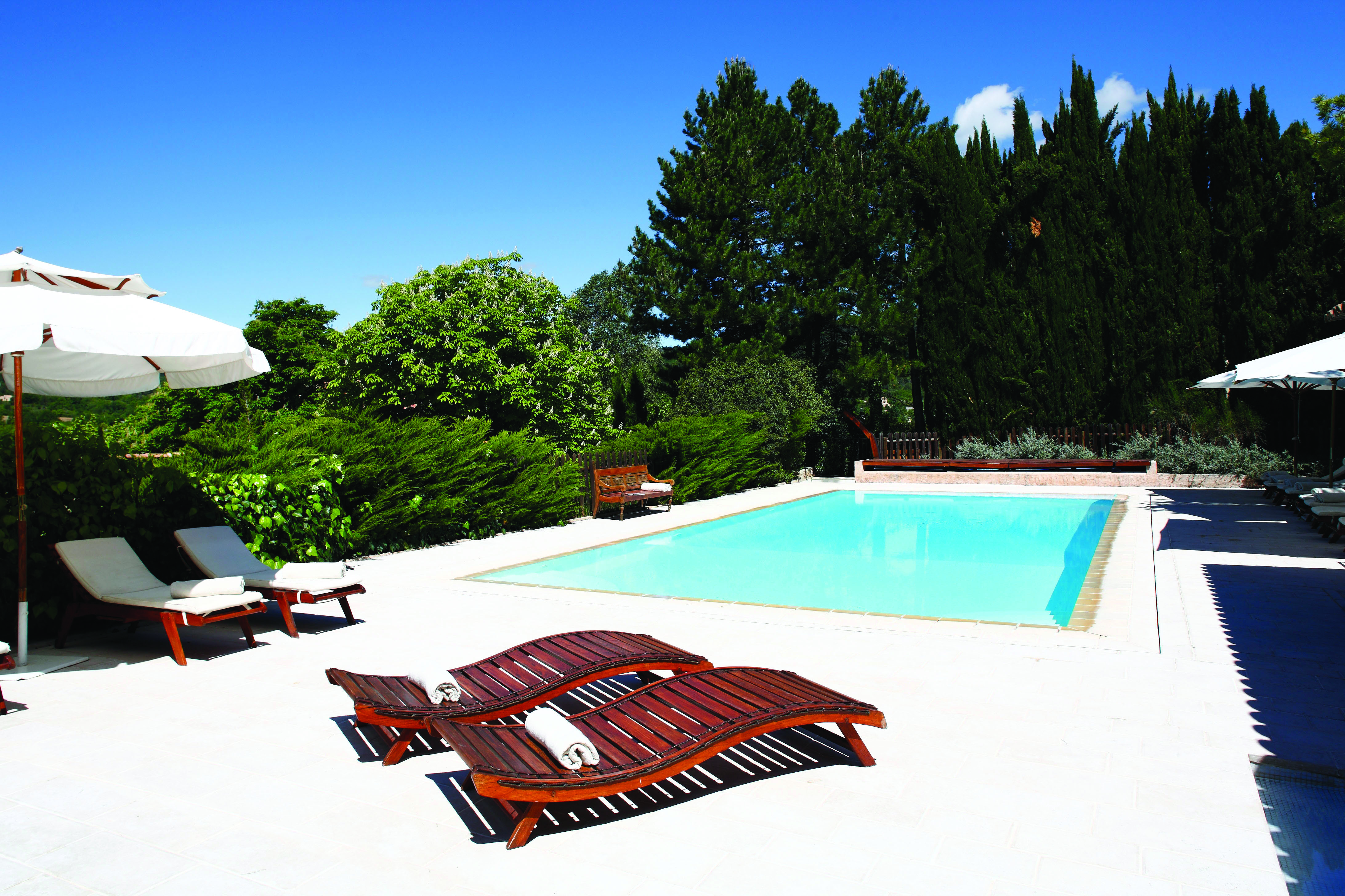 La Bastide de Moustiers Provence outdoor pool with two wooden sun loungers