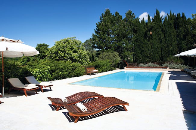 La Bastide de Moustiers Provence outdoor pool with two wooden sun loungers