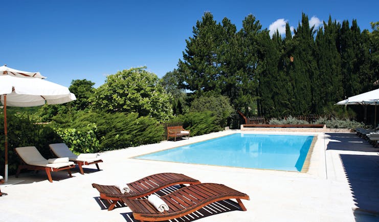 La Bastide de Moustiers Provence outdoor pool with two wooden sun loungers