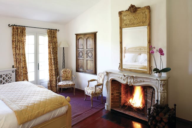 La Bastide de Moustiers Provence aviary bedroom chairs mirror above a fireplace