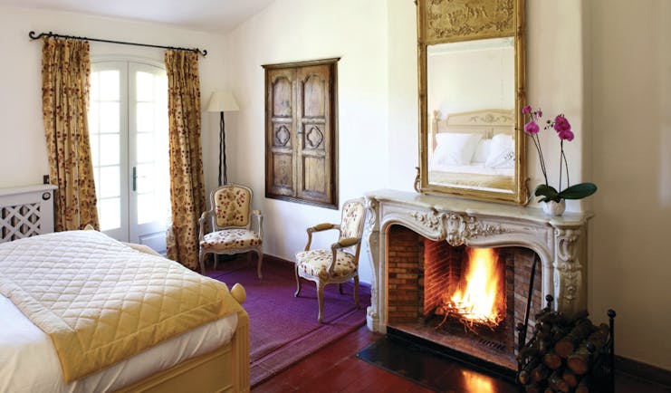 La Bastide de Moustiers Provence aviary bedroom chairs mirror above a fireplace