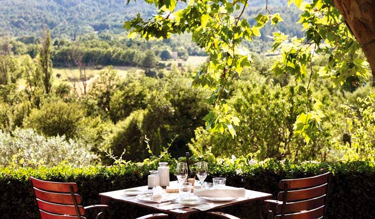 La Bastide de Moustiers Provence terrace dining area overlooking wooded area