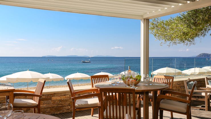 Terrace with chairs and tables over looking beach and sea at Pinede Plage