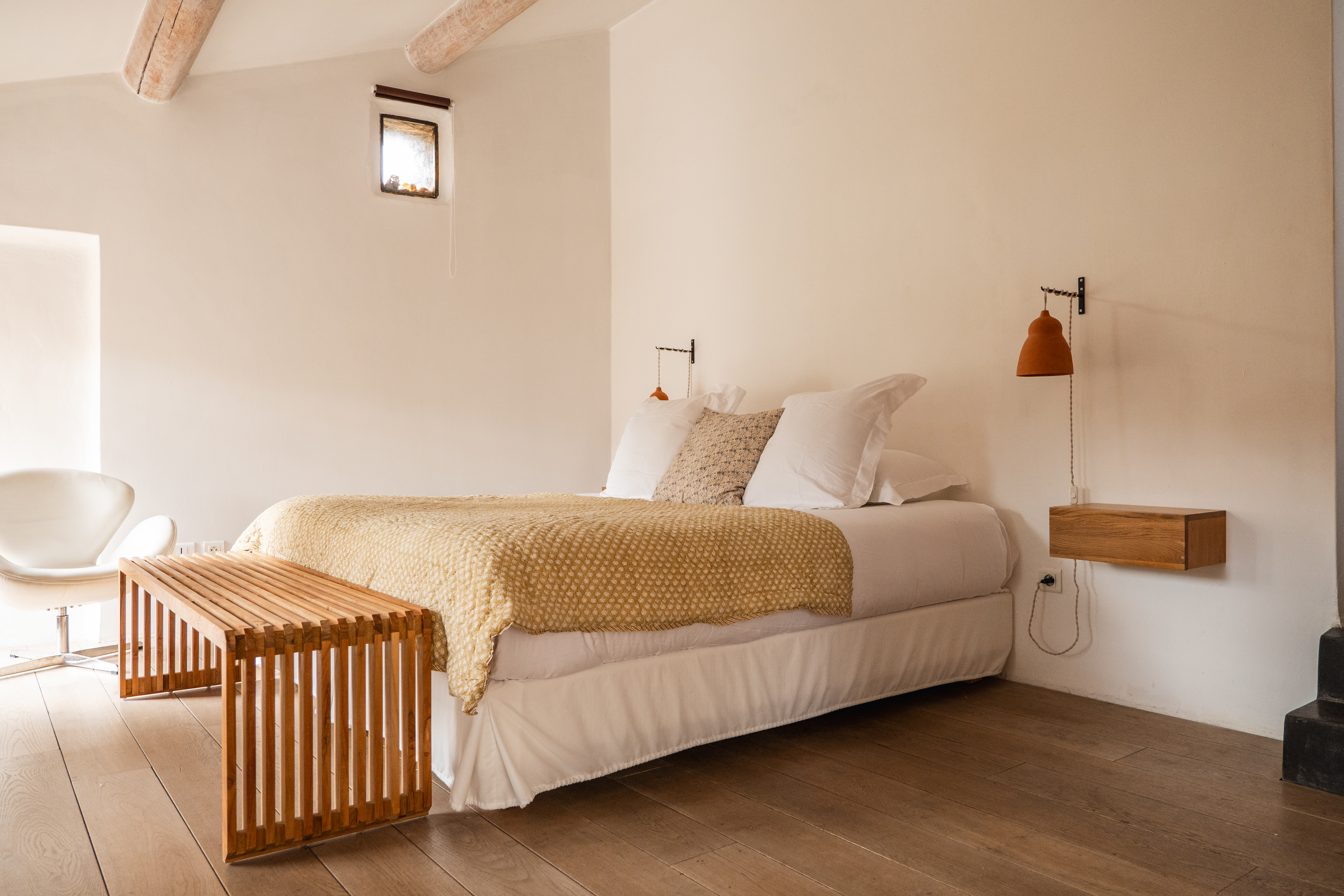 Le Galinier white-themed bedroom with double bed and wooden floors