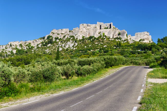 Hill town of Les Baux de Provence with road in foreground