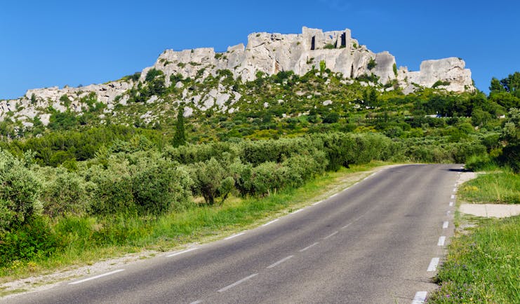 Hill town of Les Baux de Provence with road in foreground