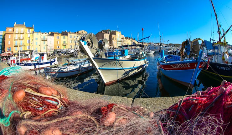 Fishing boats and nets on harbour side in St Trpoez