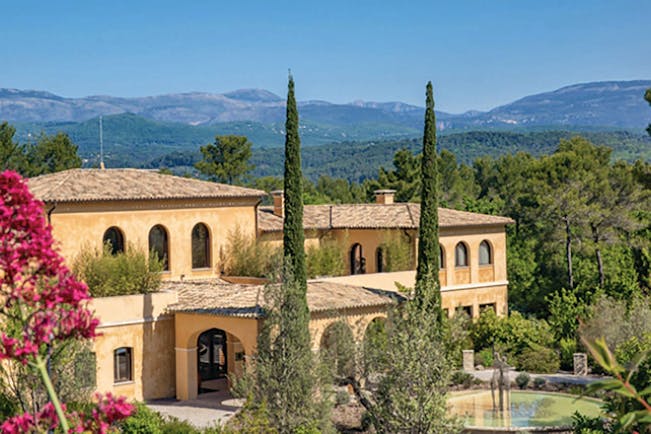 Terre Blanche Hotel and Spa Provence exterior large yellow building with arched windows and archways