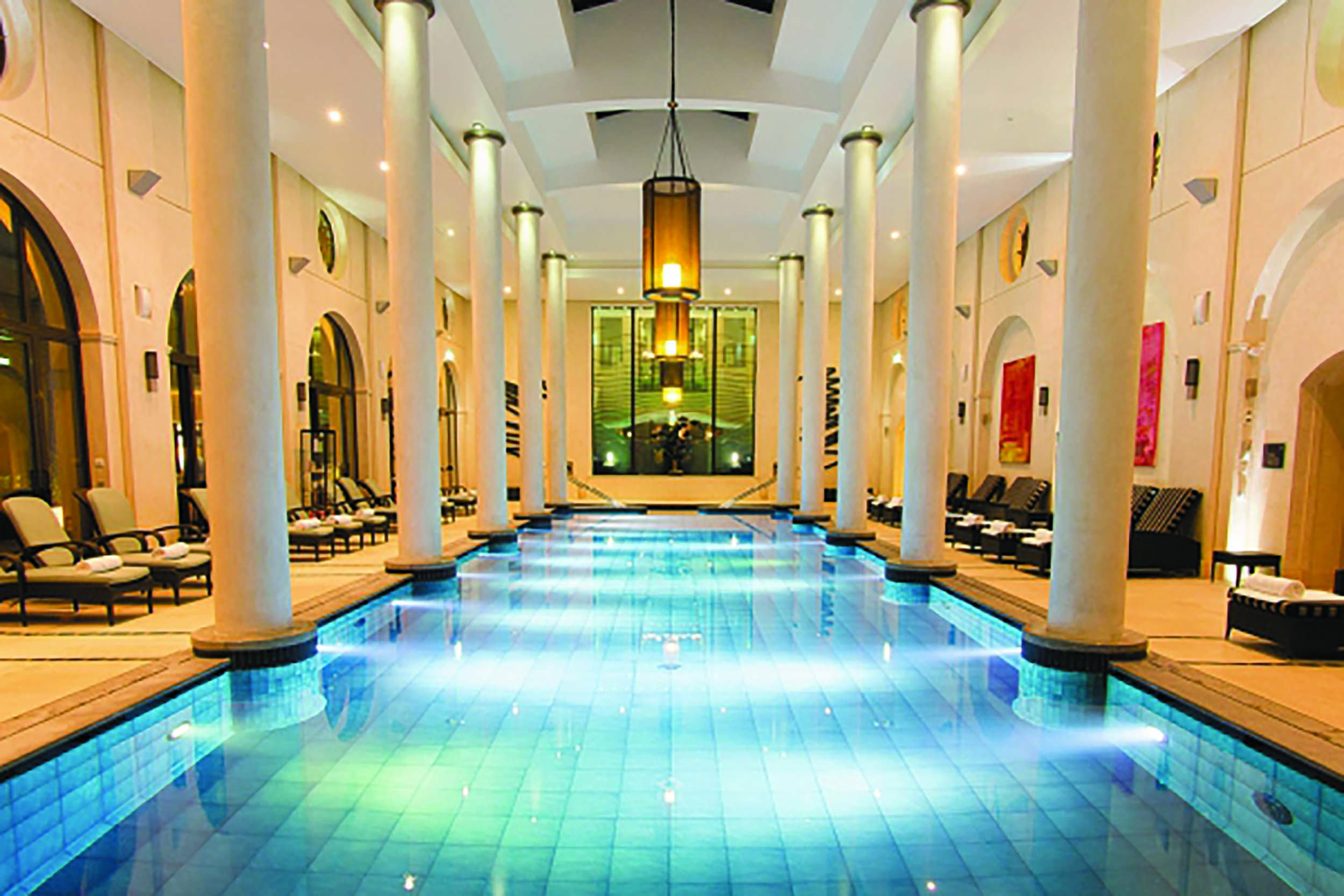 Terre Blanche Hotel and Spa Provence indoor spa pool with wooden loungers and round columns