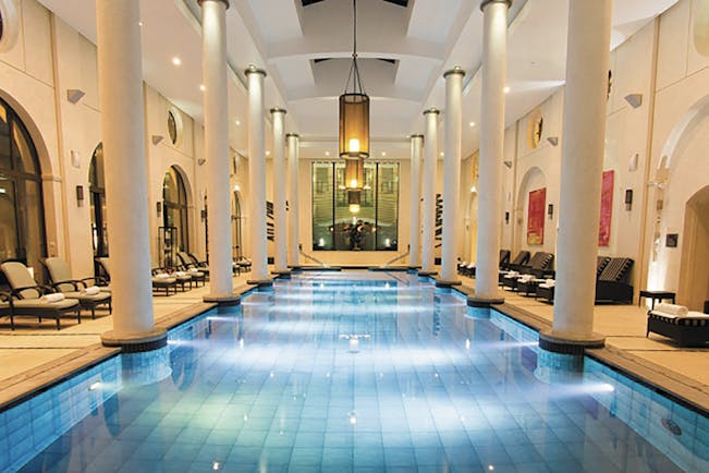 Terre Blanche Hotel and Spa Provence indoor spa pool with wooden loungers and round columns