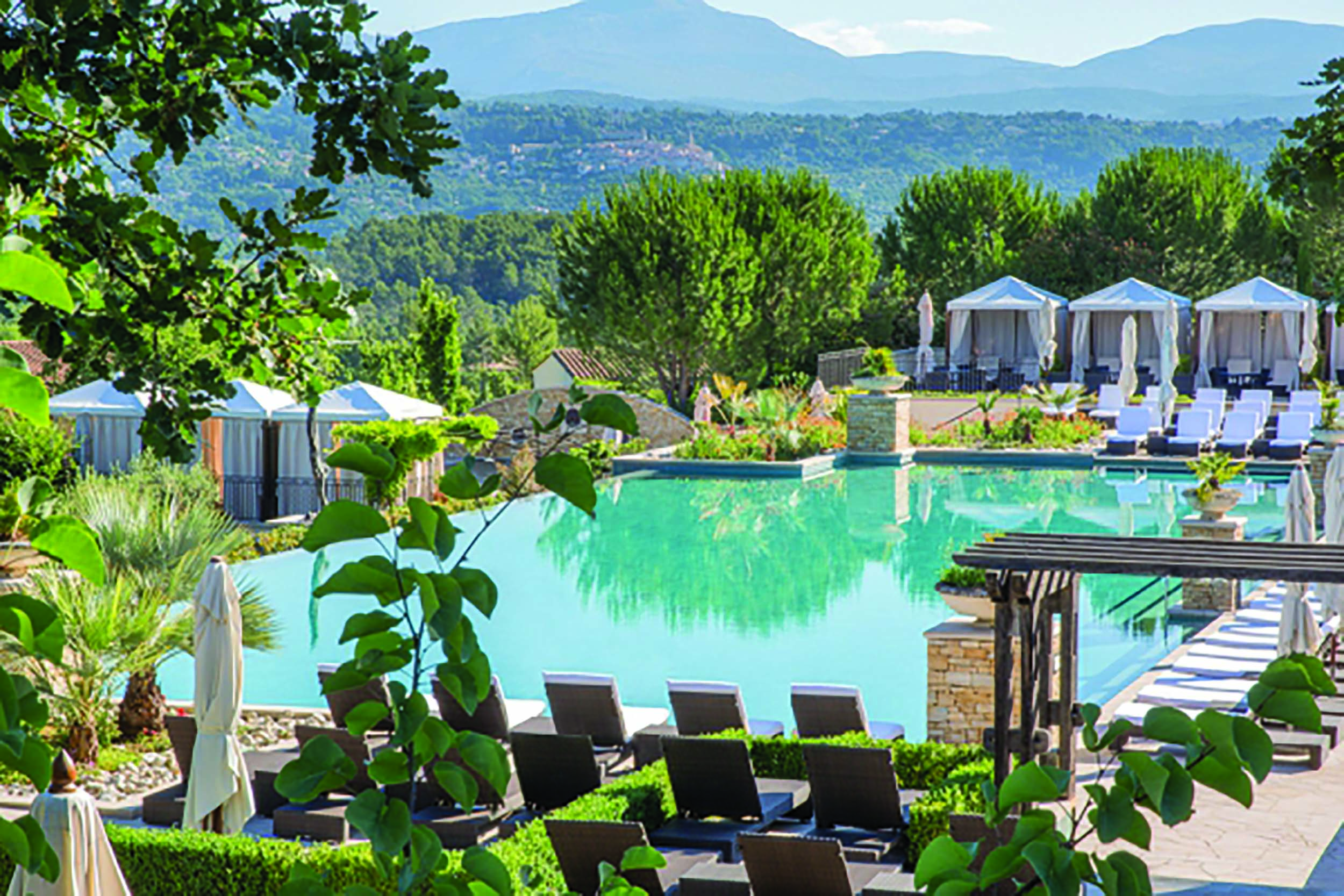 Terre Blanche Hotel and Spa Provence infinity pool with white sun loungers and cabanas