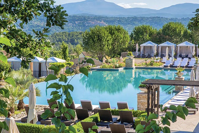 Terre Blanche Hotel and Spa Provence infinity pool with white sun loungers and cabanas