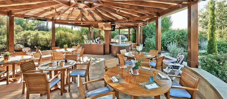 Terre Blanche Hotel and Spa Provence kids restaurant dining pagoda dining area with several tables and a high chair