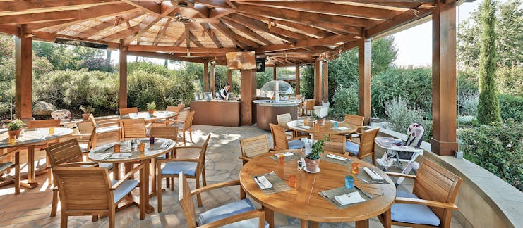 Terre Blanche Hotel and Spa Provence kids restaurant dining pagoda dining area with several tables and a high chair