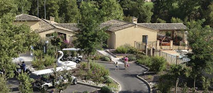 Terre Blanche Hotel and Spa Provence outdoor villa buildings and golf buggy
