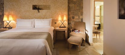 Terre Blanche Hotel and Spa Provence prestige bedroom with yellow walls two bedside tables and lamps