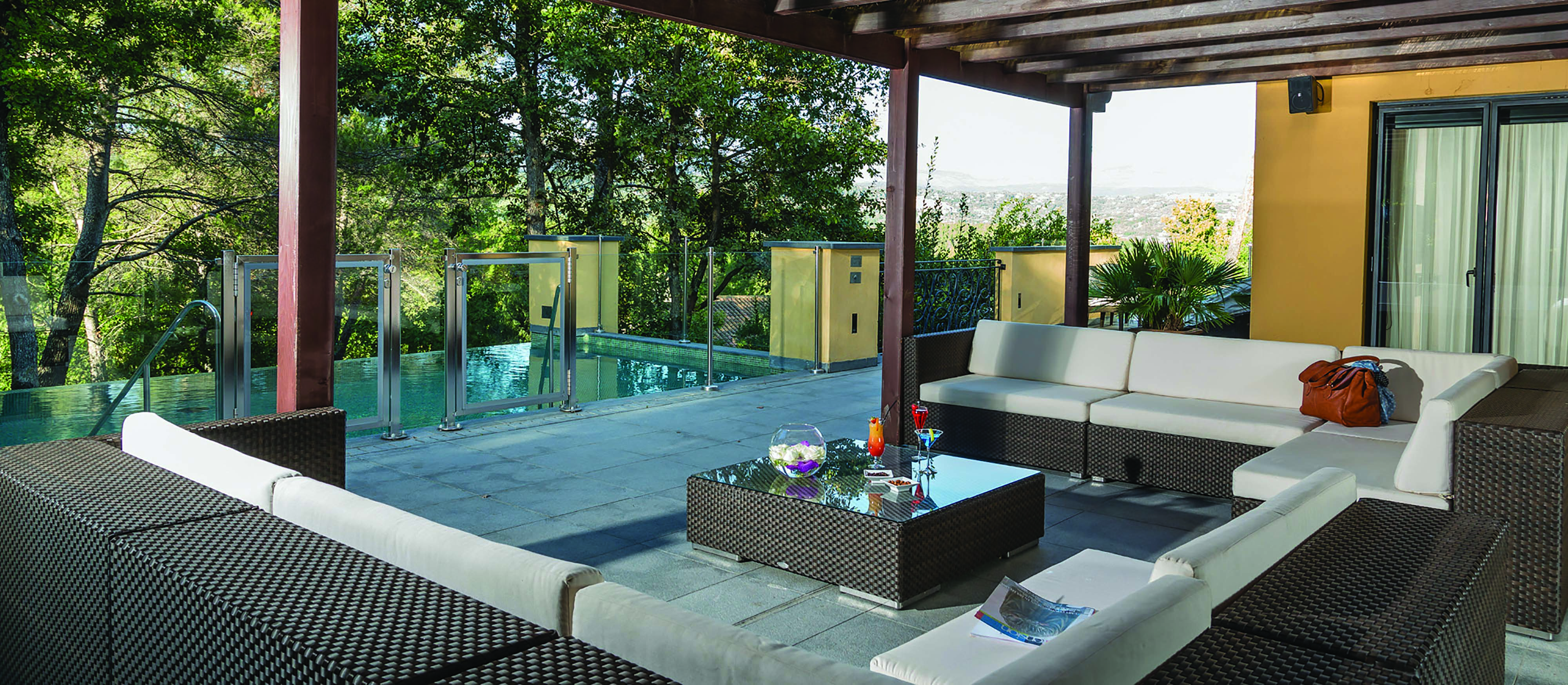 Terre Blanche Hotel and Spa Provence prestige villa several sofas on a patio overlooking a small infinity pool